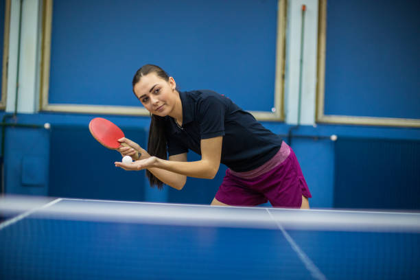 istock Beautiful young woman playing table tennis 907246796