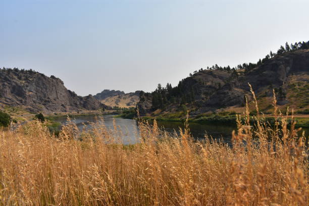 The peaks of the Adel Mountains rise behind and around Hardy Bridge as it carries Old U.S. 91 across the Missouri River in Montana.
