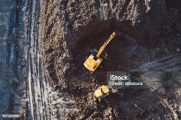 Aerial Drone View Of Excavator Loading The Tipper Truck Stock Photo - Download Image Now
