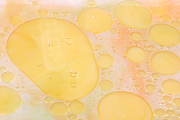 istock Drops of vegetable oil on liquid, abstract background, pop art texture, yellow circles on a light background, minimalism, pastel pattern 907269156