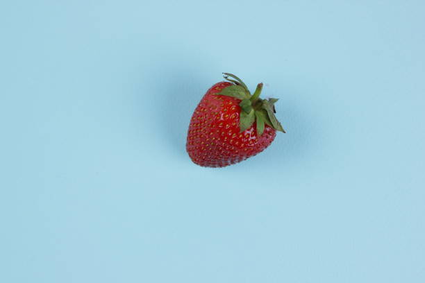 istock Strawberry pop art, red berries on a blue background, minimalism, forest berries for dessert, healthy food, vitamins 907289878