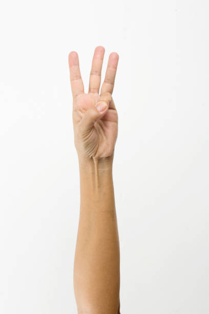 istock Woman right hand showing the three fingers insulated. 907291102
