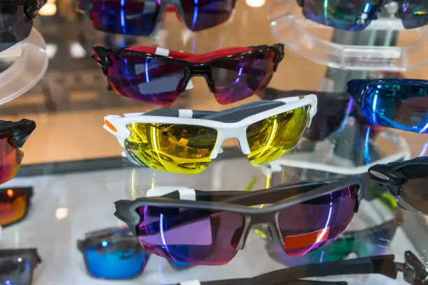 Photo of Various of sun glasses in the shop display shelves. Selective focus