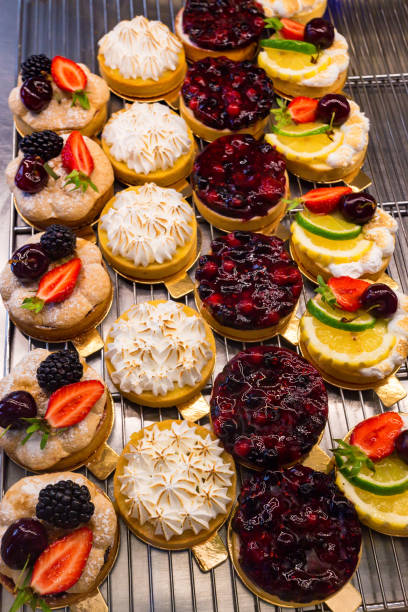 istock Dessert tartlets with fruit and berries top view 907292684
