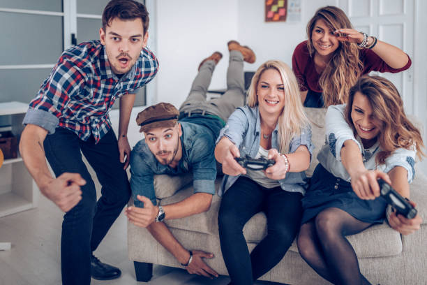 playing games in office on coffee break - gamer watching tv adult couple imagens e fotografias de stock