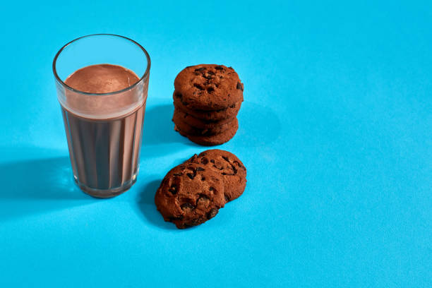 istock Chocolate milk with cookies on blue background with space for text or design 907318180