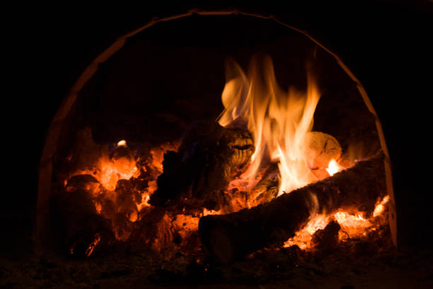 Russian stove. Red orange yellow burning wood. Traditional furnace with flame, firewood and coals.