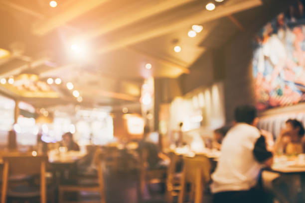 istock Restaurant cafe or coffee shop interior with people abstract blur background 907337750