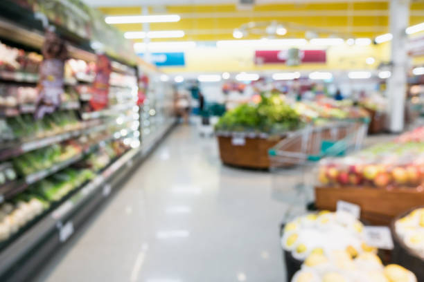 istock Supermarket grocery store with fruit and vegetable on shelves blurred background 907337780