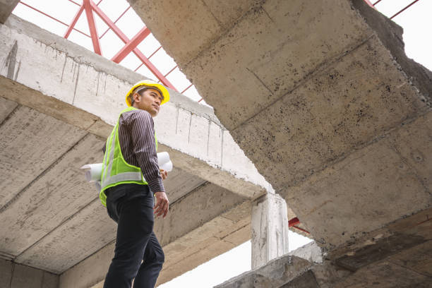 istock professional engineer worker at the house building construction site 907337866