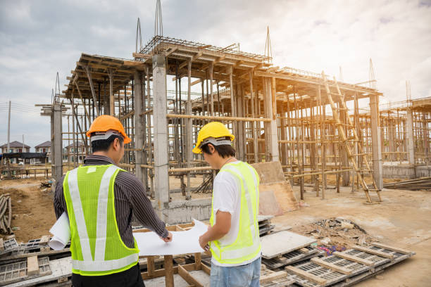 istock Asian business man construction engineer workers at house building site 907337878