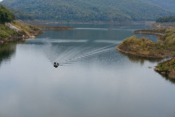 Chiang Mai, Thailand - January 14, 2018: local fisherman sailing on sailboat at Mae Kuang Udom Thara dam in Chiang Mai, Thailand on January 14, 2018.
