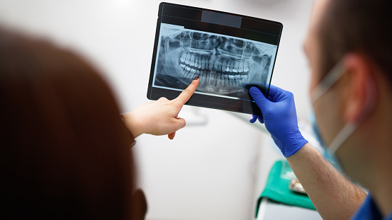 Dentist showing a patient her x-ray at dentist's office
