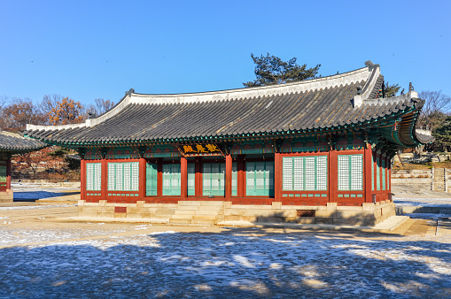 Changgyeonggung Palace in Seoul was built in the mid-15th century and is one of the most popular tourist attractions in the city. It is a large sprawling complex with a 'secret' garden in the back. This photo shows the palace and it's detailed architecture. The photo was taken during a cold winter day.