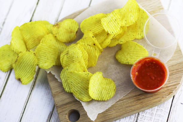 istock Potato chips on a wooden tray 907343424
