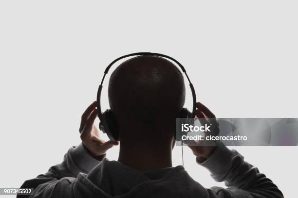 Male Silhouette With Hands Holding Headphones Stock Photo - Download Image Now - Headphones, Listening, Music