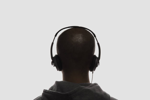 Male silhouette with headphones on white background.