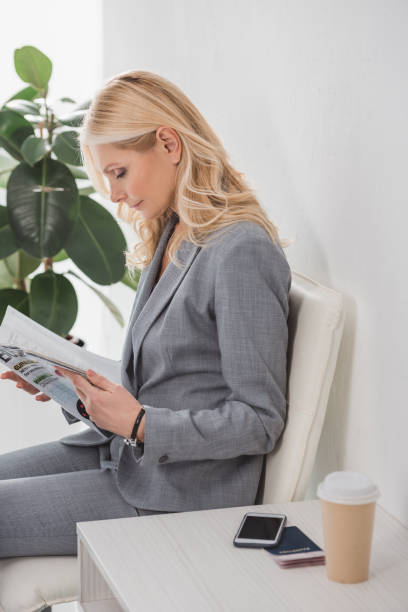 istock businesswoman reading magazine 907349758