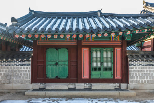 Changgyeonggung Palace in Seoul was built in the mid-15th century and is one of the most popular tourist attractions in the city. It is a large sprawling complex with a 'secret' garden in the back. This photo shows the palace and it's detailed architecture. The photo was taken during a cold winter day.