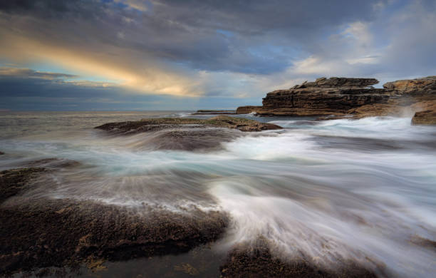 istock Coastal ocean flows over rocks and cunjevoi 907354906