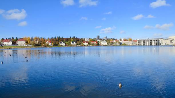 istock Clouds Reflected in Tjornin Pond in Reykjavik Iceland 907363584