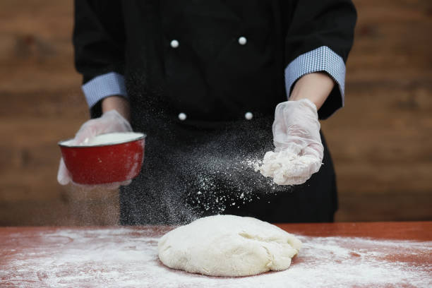 istock the cook makes flour for baking on the table 907363588