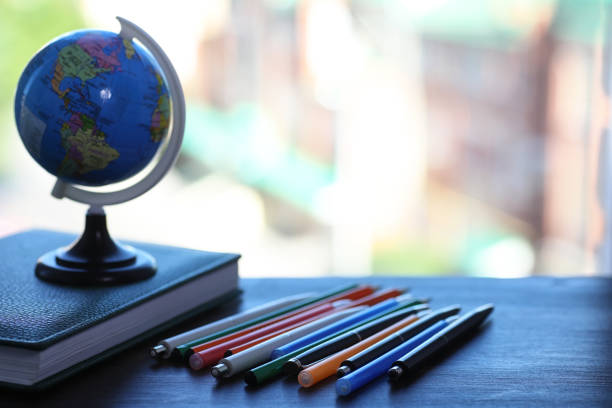istock A pen on the desk and a small globe 907365780