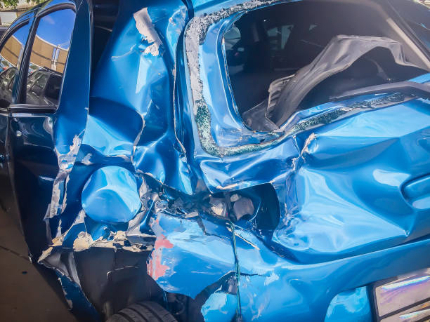 istock Close-up front of blue new car distorted by accident. Crashed new blue car severely damaged and needs help for move to the garage to repair and call to loss adjuster for car insurance claim. 907374632