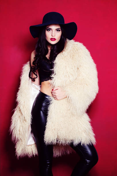 istock Fashion Woman Posing on Red Background 907374702