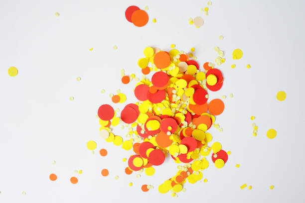 istock Bright festive decor. Red, yellow confetti, the serpentine on a white background 907380460