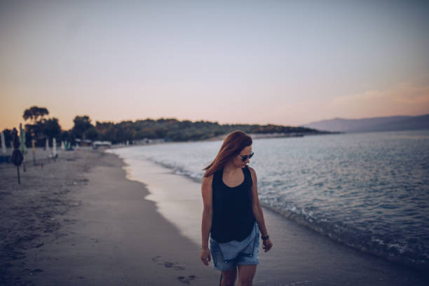 istock Beautiful woman at the beach 907380506
