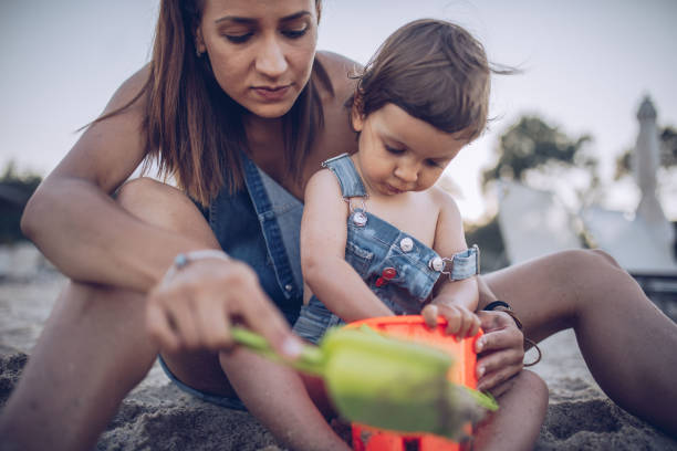 istock Mother playing with baby daughter 907380610