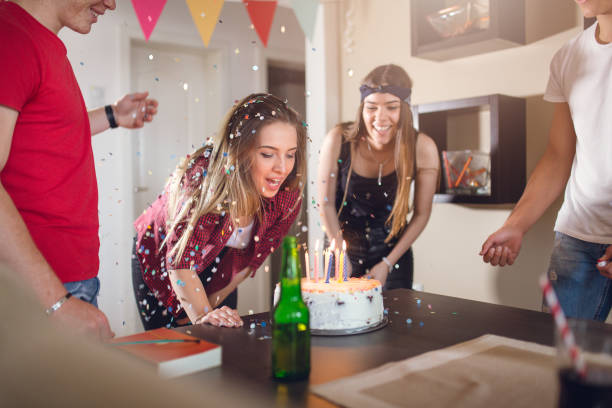 istock Excited young woman gets birthday cake 907380874