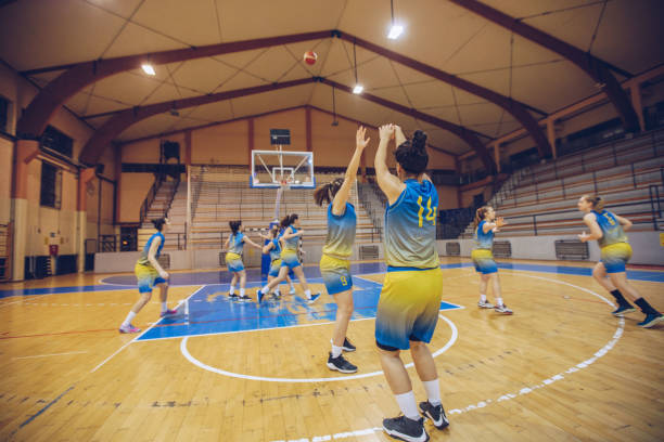 istock Young woman playing basketball 907380974
