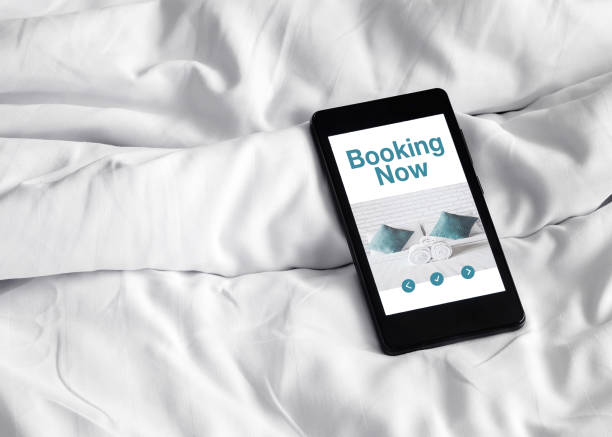 online booking on cellphone stock photo