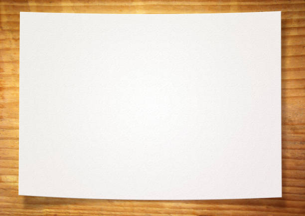 istock White blank paper on wood texture 907391394