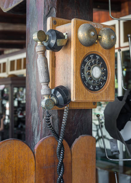 istock Vintage telephone hang on wooden pole 907393700