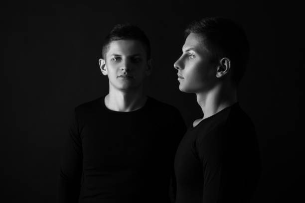 istock Two attractive positive young twin brothers standing dressed in 907398586