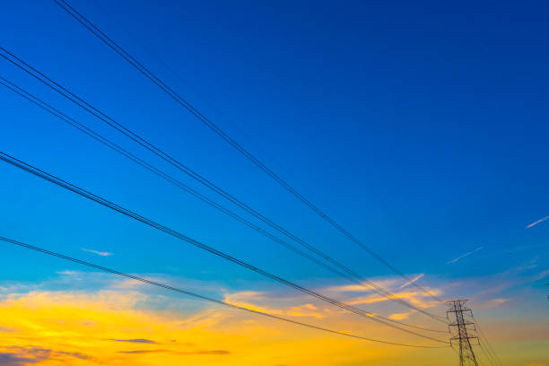 istock Electricity station. Close up high voltage power lines at sunset. 907398856