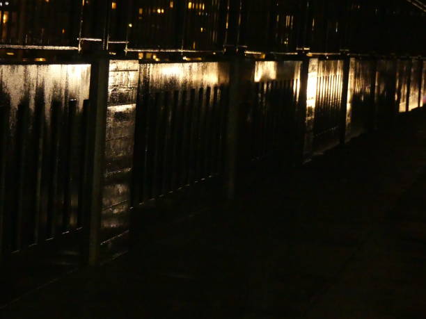 istock Night road background golden reflections wet wall 907405930
