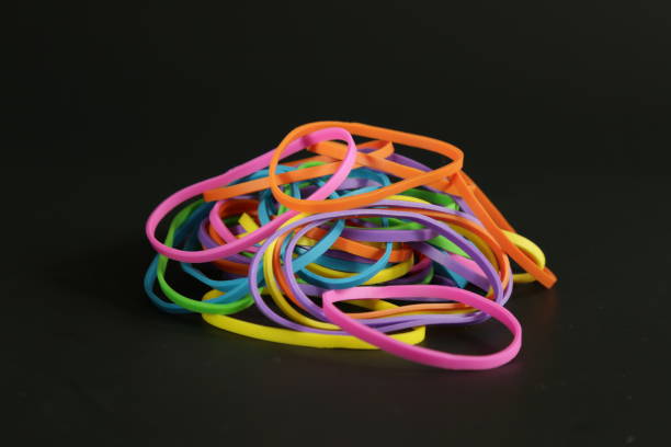 istock Rubber band colors dark background 907406522