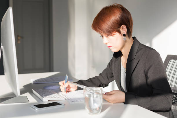 istock business woman working on office desk 907409016