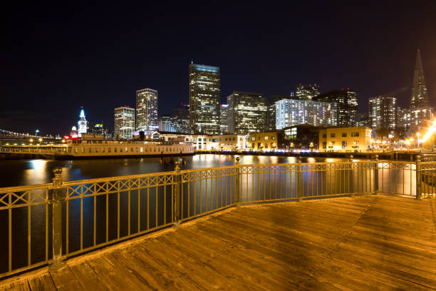 istock empty wood sidewalk near water in modern city 907417942