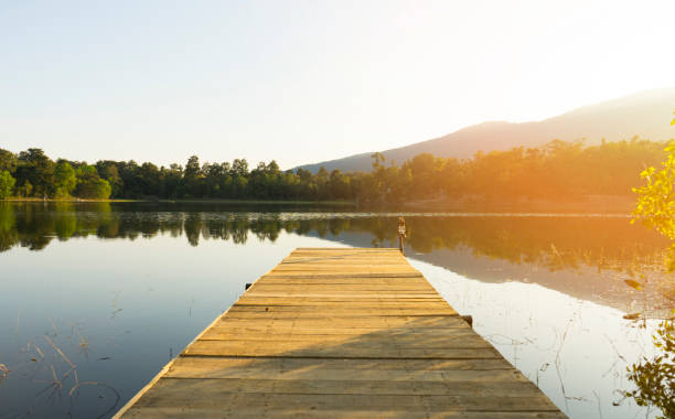 istock Boat jetty and a calm lake 907425628