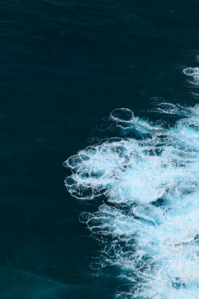istock above view of blue ocean with white wave 907444866