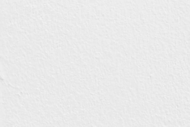 istock White concrete or cement wall with vintage style pattern for background and design art work, old grungy texture. 907458278