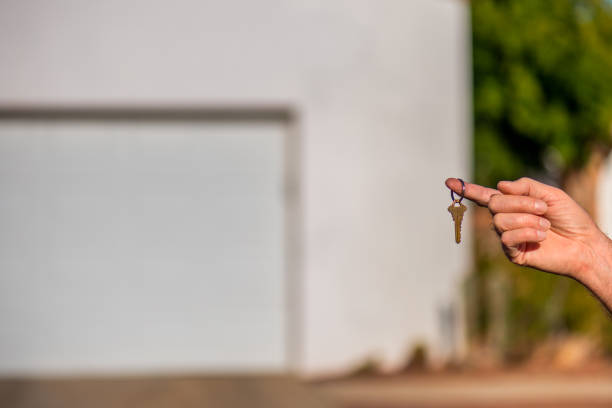 istock Handing over the key to a new house 907458586