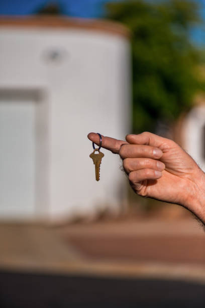 istock Handing over the key to a new house 907458608
