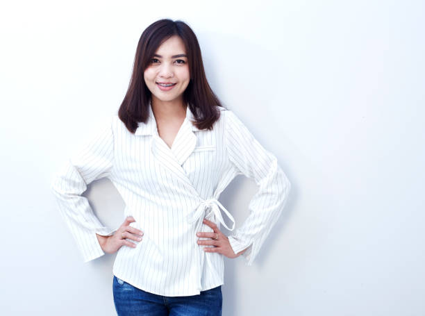 istock Beautiful girl in jeans on a white background 907466896