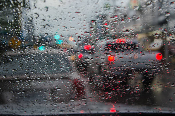 istock Rain drop on traffic jam and electric light in the night. blur abstract background. 907469774